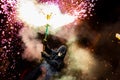 Young man lighting up a firecracker in his hand outdoors Royalty Free Stock Photo