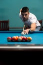 Young Man Lining To Hit Ball On Pool Table Royalty Free Stock Photo