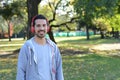 Young man listening to music with headphones in park. Royalty Free Stock Photo