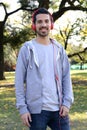 Young man listening to music with headphones in park. Royalty Free Stock Photo