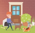 Young man with little dogs mascots in the house garden Royalty Free Stock Photo