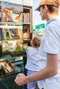 Young man and little girl old takes books from free book exchange point. Rostov-on-Don, Russia, august 07 2021 Royalty Free Stock Photo