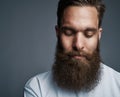 Young man with a long beard deep in thought Royalty Free Stock Photo