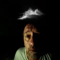 Young man with a look and expression of anguish with a cloud over his head Royalty Free Stock Photo
