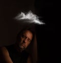 Young man with a look and expression of anguish with a cloud over his head Royalty Free Stock Photo