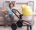 Young man looking after baby in pram Royalty Free Stock Photo