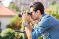 Young man looking through binocular searching Royalty Free Stock Photo