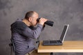 Young man looking with binoculars at the screen Royalty Free Stock Photo