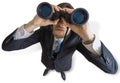 Young man is looking with binoculars at you. Isolated on white background Royalty Free Stock Photo