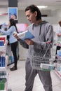 Young man looking at box of sleeping pills Royalty Free Stock Photo