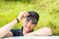 Young man looking at camera outdoor, leaning with Royalty Free Stock Photo