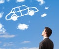 young man looking at car cloud on a blue sky Royalty Free Stock Photo
