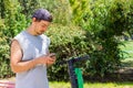 Young man looking at cellphone with electric scooter at park Royalty Free Stock Photo