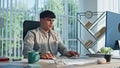Young man looking desktop working at open space closeup. Manager drinking tea Royalty Free Stock Photo