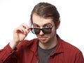 Young man looking disparaging over the sunglasses Royalty Free Stock Photo