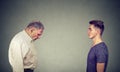 Young man looking at elder depressed himself