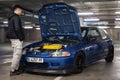 A young man looking at the engine of a Honda Civic EG 1.6 Vtec, the car is blue in color Royalty Free Stock Photo