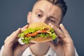 Young man looking at a fresh burger Royalty Free Stock Photo