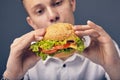 Young man looking at a fresh burger Royalty Free Stock Photo