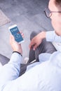 Young man is looking at incoming e-mail on his smartphone Royalty Free Stock Photo