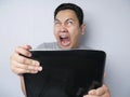 Young Man Looking at Laptop, Angry Gesture Royalty Free Stock Photo