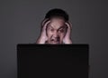 Young Man Looking at Laptop, Angry Gesture