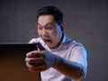 Young Man Looking at Laptop, Angry Gesture