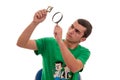 Young man looking with a magnifying glass at a photographic film