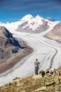 Young man looking at majestic view to Aletsch glacier, the large