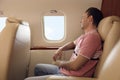 Young man looking out window in airplane during flight Royalty Free Stock Photo