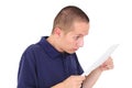 Young man looking at paper with disbelief Royalty Free Stock Photo