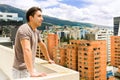 Young man looking at Quito city view from balcony Royalty Free Stock Photo