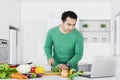 Young man looking recipe on laptop Royalty Free Stock Photo