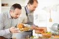 Young man preparing turkey for dinner Royalty Free Stock Photo