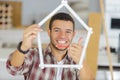 Young man looking through ruler bent into house shape Royalty Free Stock Photo