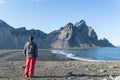 Young man looking at a scenic beach in Iceland