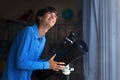 Young man looking at stars through telescope