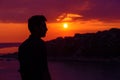 Young man is looking at the sunset thinking Royalty Free Stock Photo