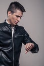 Young man, looking to watch, leather jacket,