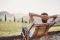 Enjoying life. Young man looking at the valley in Italy, relaxation, vacations, lifestyle concept