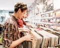 A Young man looking at vinyl records in a store or shop. Royalty Free Stock Photo