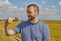 A young man looks at a red swamp crayfish caught in a rice field Royalty Free Stock Photo