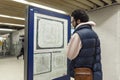 A young man looks at the subway map. Paris, France, 10-08-2019 Royalty Free Stock Photo