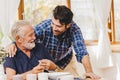 Young man love and care elder eating lunch meal for safe and stay at home happy smile family