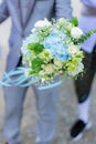 The young man is in love. Holding a white bouquet To give to a beloved wonan on green bokeh background