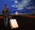 Young man and luggage on airport runways