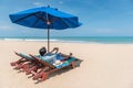 Young man lying on beach bench and take photos Royalty Free Stock Photo