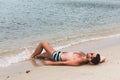 Young man lying on the beach