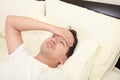 Young man lying down in bed Royalty Free Stock Photo