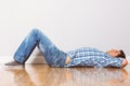 Young man lying on floor thinking Royalty Free Stock Photo